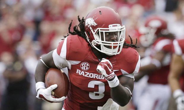 Alex Collins was one of three running backs and eight offensive players total taken in the draft by...