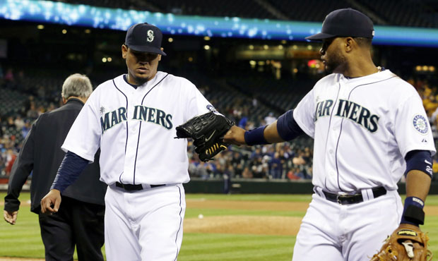 Seattle Mariners starting pitcher Felix Hernandez left, is greeted by Seattle Mariners second basem...