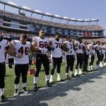
              Members of the Houston Texans team stand with arms locked during the national anthem before an NFL football game against the New England Patriots, Sunday, Sept. 24, 2017, in Foxborough, Mass. (AP Photo/Steven Senne)
            