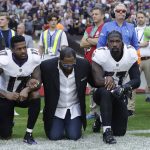 
              Baltimore Ravens wide receiver Mike Wallace, from left, former player Ray Lewis and inside linebacker C.J. Mosley lock arms and kneel down during the playing of the U.S. national anthem before an NFL football game against the Jacksonville Jaguars at Wembley Stadium in London, Sunday Sept. 24, 2017. (AP Photo/Matt Dunham)
            