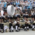 
              New Orleans Saints players sit on the bench during the national anthem before an NFL football game against the Carolina Panthers in Charlotte, N.C., Sunday, Sept. 24, 2017. (AP Photo/Bob Leverone)
            