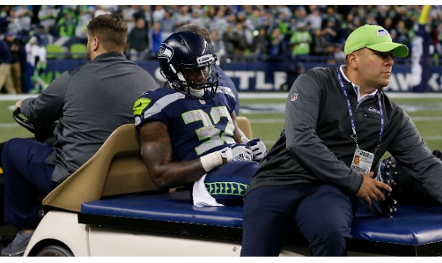 Chris Carson had to be carted off the field in the fourth quarter with a leg injury. (AP)...