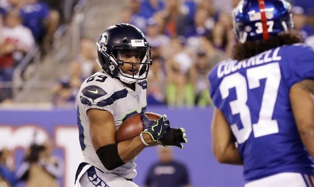 Seattle Seahawks' Doug Baldwin, center, scores a touchdown during the second half of an NFL footbal...