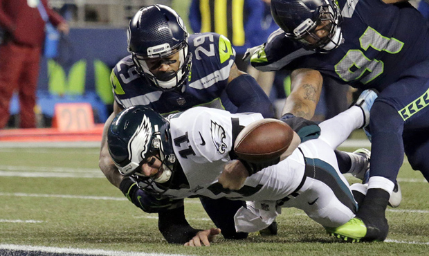 Philadelphia Eagles quarterback Carson Wentz (11) fumbles the ball near the goal line and into the ...