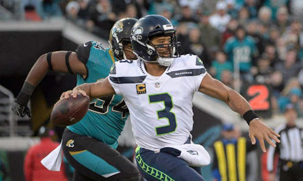 Russell Wilson threw three picks as the Seahawks lost the turnover battle to the Jaguars. (AP)...