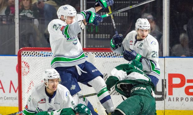 Jarret Tyszka, Matthew Wedman, and Nolan Volcan fight off Everett attackers Saturday night (Brian L...