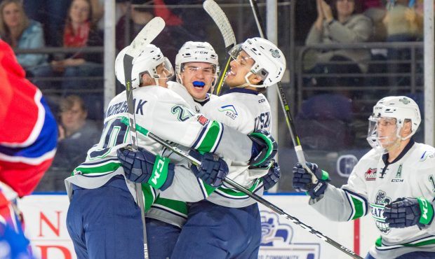 Zach Andrusiak and Jarret Tyszka hug Donovan Neuls after one of his two goals Saturday (Brian Liess...