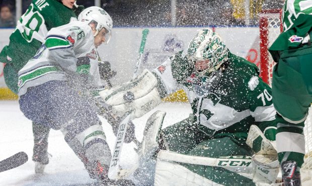 Seattle's Nolan Volcan crashes the Everett net, spraying goalie Carter Hart during the T-Birds 3-2 ...