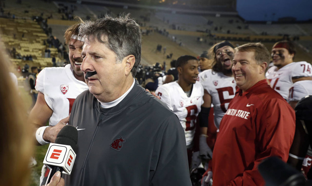 WSU coach Mike Leach and mustachioed QB, Gardner Minshew, take on Arizona Saturday. (AP)...