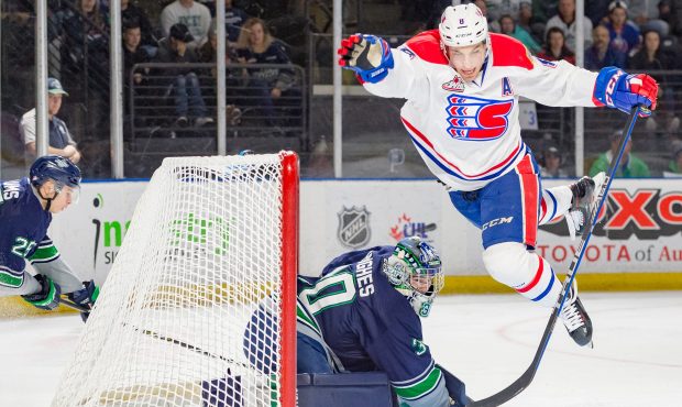 Riley Woods of the Spokane Chiefs leaps over Seattle goalie Liam Hughes Friday night (Brian Liesse/...