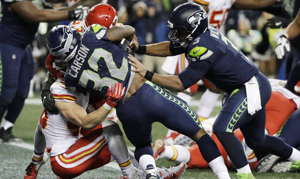 Russell Wilson gave Seahawks RB Chris Carson an assist on his fourth-quarter TD run. (AP)...