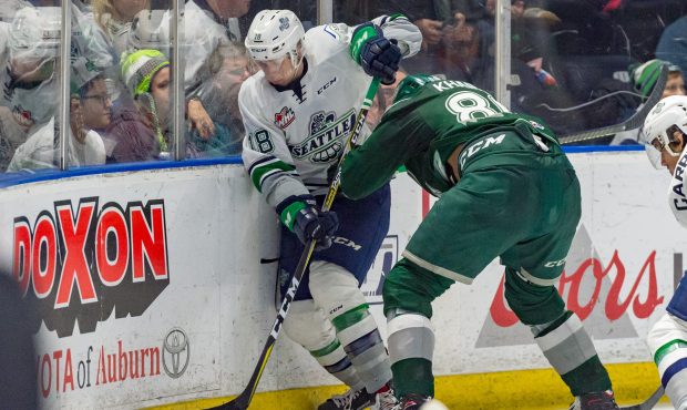 Andrej Kukuca battles along the boards with Everett's Shavan Khaira during Saturday's game (Brian L...