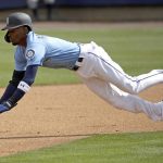 
              Seattle Mariners' Dee Gordon dives to steal second during the first inning of a spring training baseball game against the Oakland Athletics, Friday, Feb. 22, 2019, in Peoria, Ariz. (AP Photo/Charlie Riedel)
            