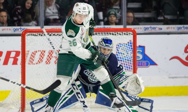 Seattle goalie Roddy Ross fights through a screen by Everett's Reece Vitelli Saturday night. (Chris...