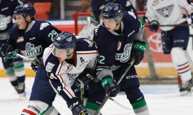 Seattle's Henrik Rybinski battles with Tri-City's Sasha Mutala during the T-Birds playoff-clinching...