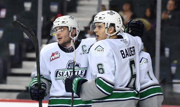 Seattle's Matthew Wedman and Tyrel Bauer hug goalie Roddy Ross after the Thunderbirds win in Calgar...