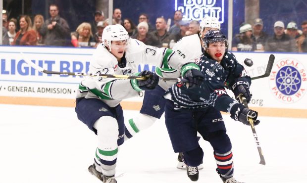Seattle's Matthew Rempe battles for a loose puck with Tri-City's Sasha Mutala Friday night. (Doug L...