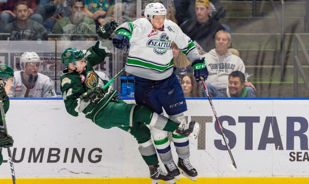 Seattle's Tyler Bauer hits Everett's Aidan Sutter during the third period of Saturday's game. (Bria...