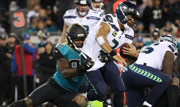 Yannick Ngakoue sacks Seahawks QB Russell Wilson...