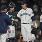 
              Seattle Mariners starting pitcher Logan Gilbert, center, is pulled during the sixth inning of a baseball game against the Oakland Athletics by manager Scott Servais, left, Wednesday, Sept. 29, 2021, in Seattle. (AP Photo/Ted S. Warren)
            