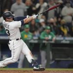 
              Seattle Mariners' Ty France hits a sacrifice fly to score Dylan Moore during the seventh inning of a baseball game against the Oakland Athletics, Wednesday, Sept. 29, 2021, in Seattle. (AP Photo/Ted S. Warren)
            