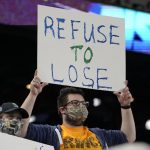 
              A Seattle Mariners fan holds a sign that reads "Refuse to Lose" before a baseball game against the Oakland Athletics, Wednesday, Sept. 29, 2021, in Seattle. (AP Photo/Ted S. Warren)
            