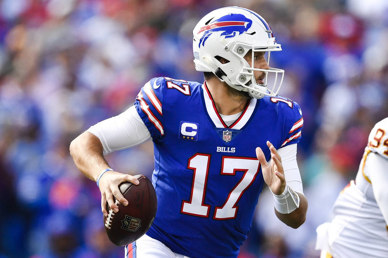 Buffalo Bills quarterback Josh Allen (17) looks to pass during the first half of an NFL football ga...