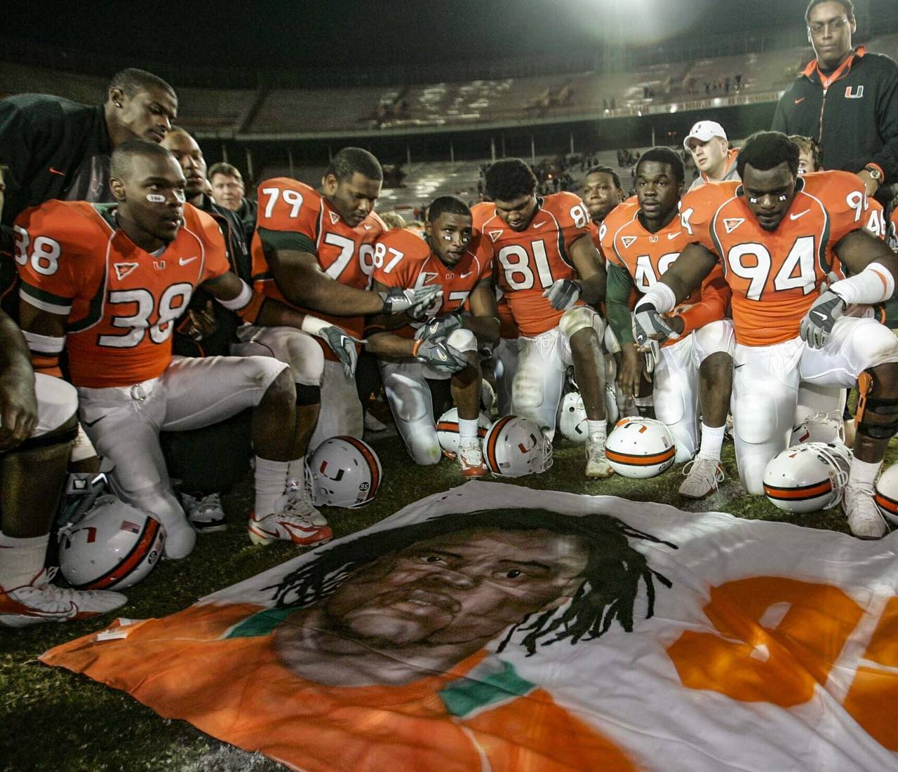 FILE - In this Nov. 23, 2006, file photo, Miami players, including Rashaun Jones (38) at left, pay ...