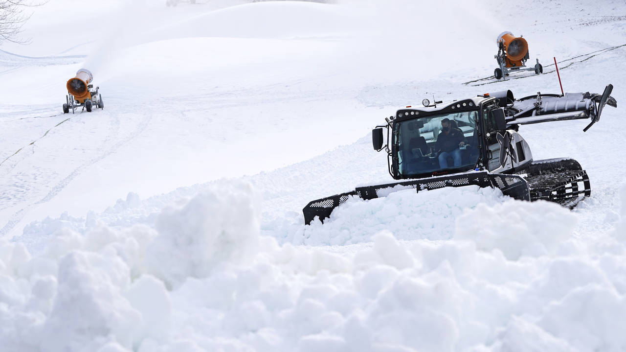 FILE— In this Dec. 16, 2020 file photograph, a snow cat grooms a trail at McIntyre Ski Area, in M...