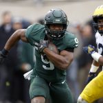 
              Michigan State's Kenneth Walker III (9) rushes against Michigan's Josh Ross during the first quarter of an NCAA college football game, Saturday, Oct. 30, 2021, in East Lansing, Mich. Michigan State won 37-33. (AP Photo/Al Goldis)
            
