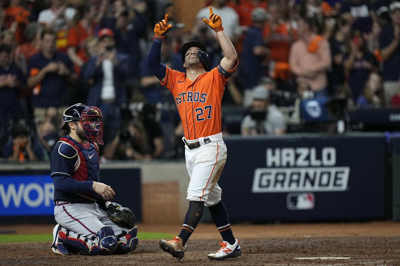 Houston Astros' Jose Altuve celebrates after a home run during the seventh inning in Game 2 of base...