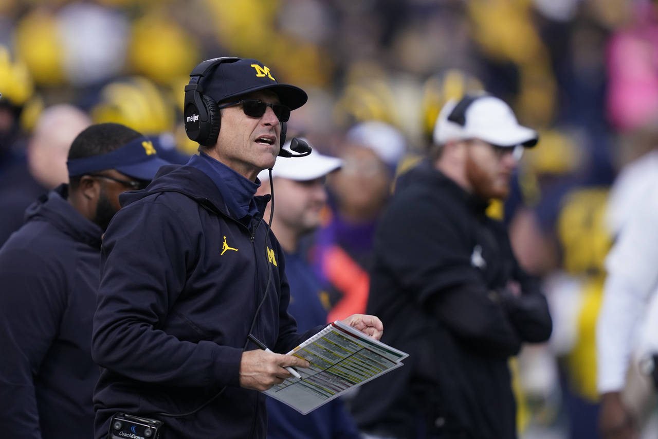 Michigan head coach Jim Harbaugh watches from the sideline during the second half of an NCAA colleg...