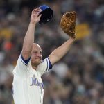 
              Seattle Mariners third baseman Kyle Seager holds his cap and glove as he responds to the crowd after being subbed out of a baseball game against the Los Angeles Angels during the ninth inning, Sunday, Oct. 3, 2021, in Seattle. (AP Photo/Ted S. Warren)
            