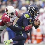 
              Seattle Seahawks quarterback Russell Wilson, right, is sacked by Arizona Cardinals' Chandler Jones during the second half of an NFL football game, Sunday, Nov. 21, 2021, in Seattle. (AP Photo/Ted S. Warren)
            