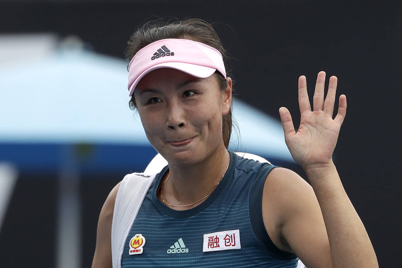 FILE - China's Peng Shuai waves after losing to Canada Eugenie Bouchard in their first round match ...