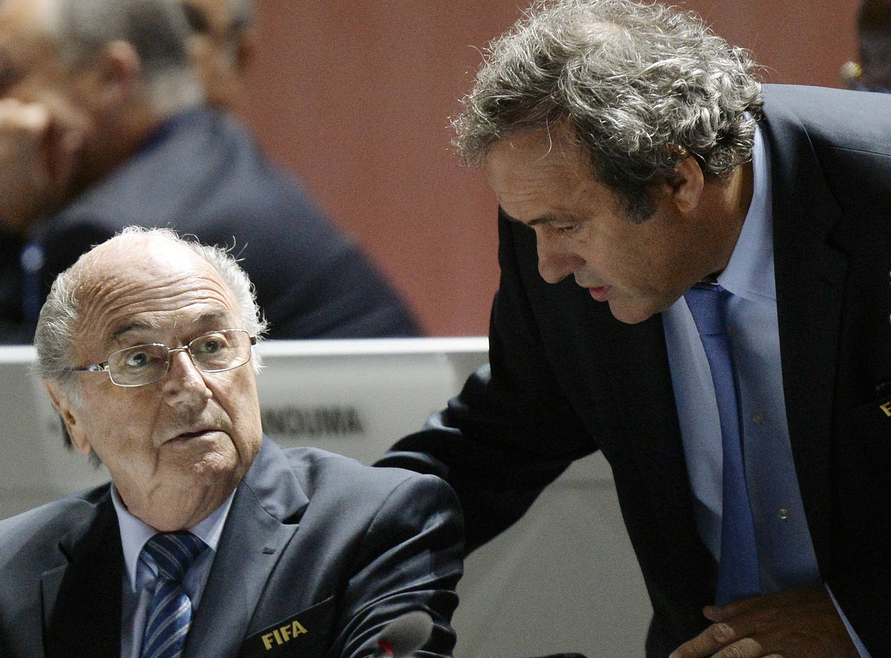 FILE - FIFA President Sepp Blatter, left, and UEFA President Michel Platini are engaged in conversa...