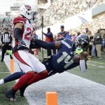 
              Seattle Seahawks wide receiver DK Metcalf (14) holds onto the ball for a catch but is ruled out of bounds as Arizona Cardinals' Marco Wilson defends during the first half of an NFL football game, Sunday, Nov. 21, 2021, in Seattle. (AP Photo/John Froschauer)
            