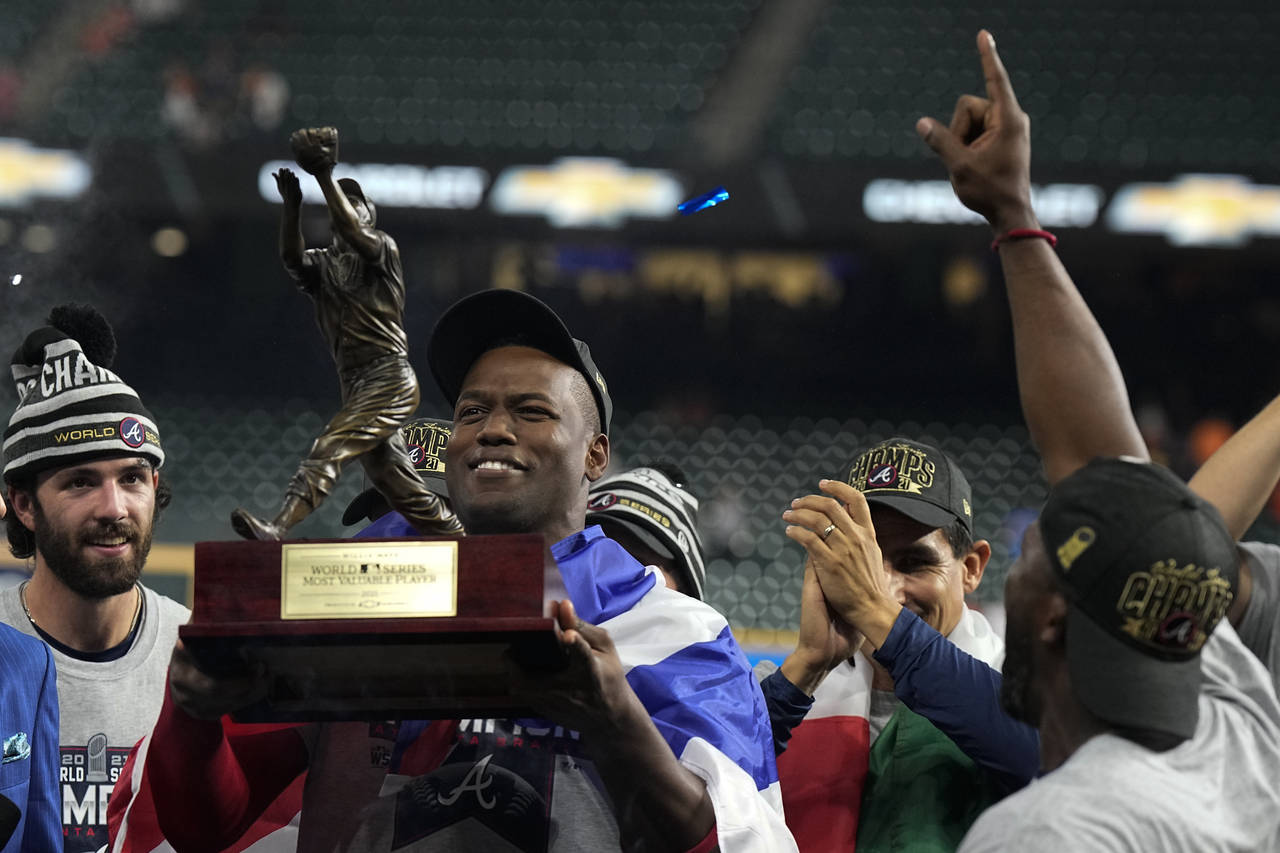 Atlanta Braves designated hitter Jorge Soler holds up the MVP trophy after winning baseball's World...