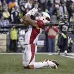 
              Arizona Cardinals running back James Conner kneels in the end zone after scoring a touchdown against the Seattle Seahawks late in the second half of an NFL football game, Sunday, Nov. 21, 2021, in Seattle. (AP Photo/Ted S. Warren)
            
