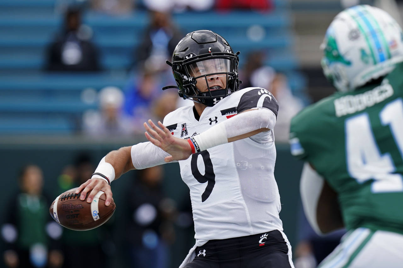 FILE - Cincinnati quarterback Desmond Ridder (9) passes during the first half of an NCAA college fo...