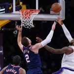Claxton oops over James late, Nets hold off Lakers 122-115