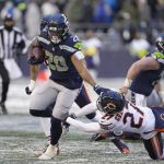 
              Seattle Seahawks running back Rashaad Penny (20) carries against the Chicago Bears during the second half of an NFL football game, Sunday, Dec. 26, 2021, in Seattle. (AP Photo/Stephen Brashear)
            