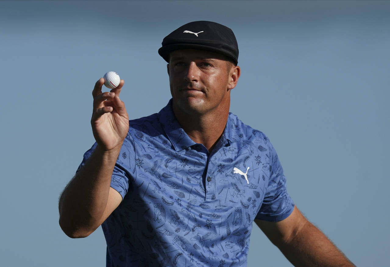 Bryson DeChambeau, of the United States, reacts to his putt on the 18th hole during the second roun...