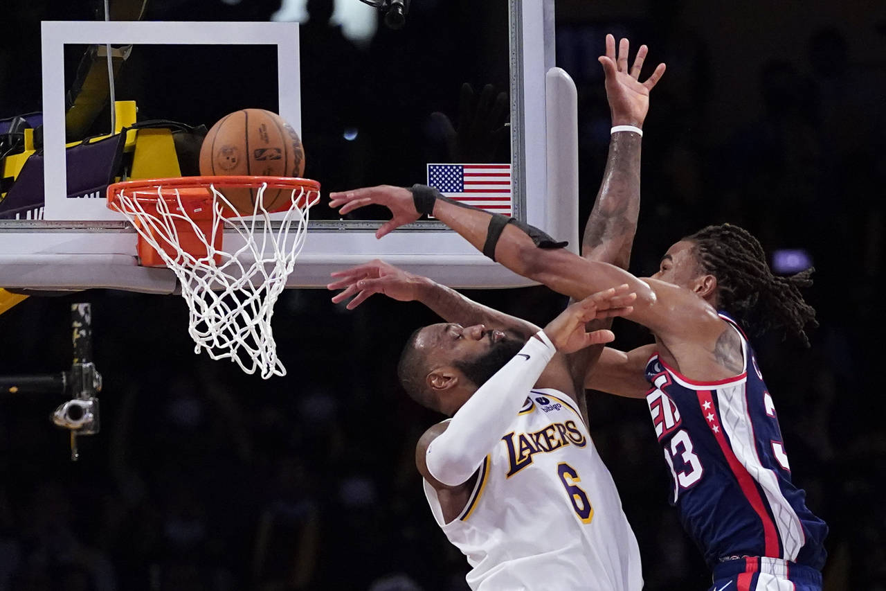 Brooklyn Nets forward Nic Claxton (33) dunks over Los Angeles Lakers forward LeBron James (6) durin...