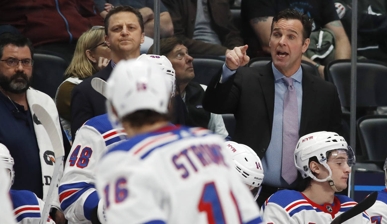 FILE - New York Rangers head coach David Quinn, right, gestures in the second period of an NHL hock...