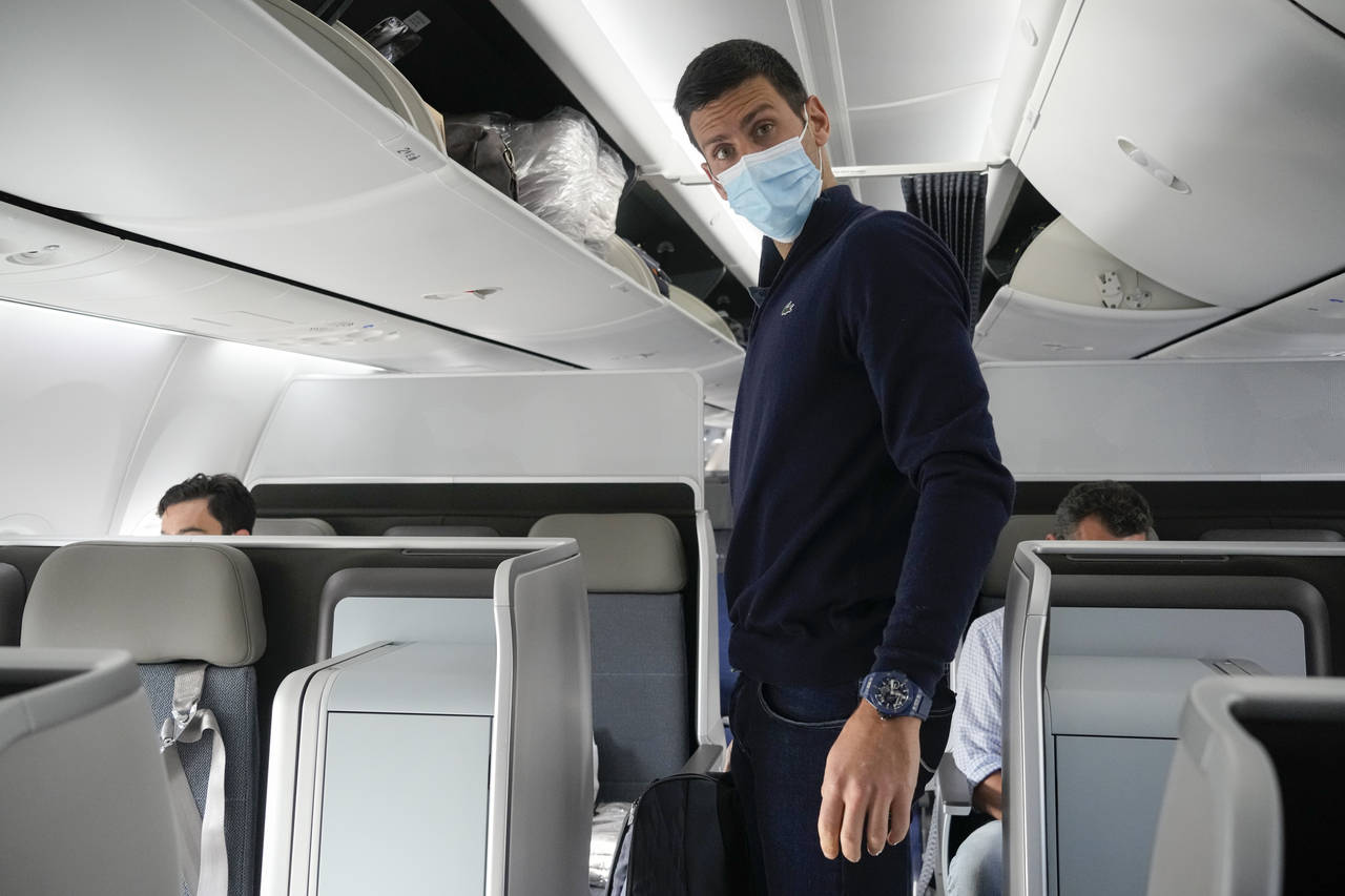 Novak Djokovic prepares to take his seat on a plane to Belgrade, in Dubai, United Arab Emirates, Mo...