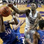 
              Kansas guard Ochai Agbaji (30) beats Kansas State forward Kaosi Ezeagu (20) to a rebound during the second half of an NCAA college basketball game Saturday, Jan. 22, 2022, in Manhattan, Kan. Kansas won 78-75. (AP Photo/Charlie Riedel)
            
