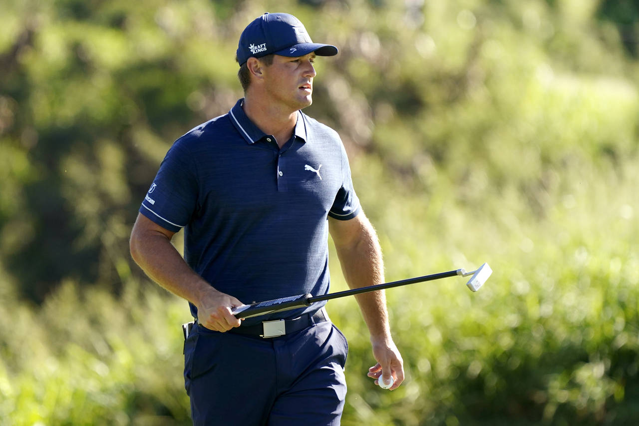 Bryson DeChambeau walks off the first green after making par during the final round of the Tourname...