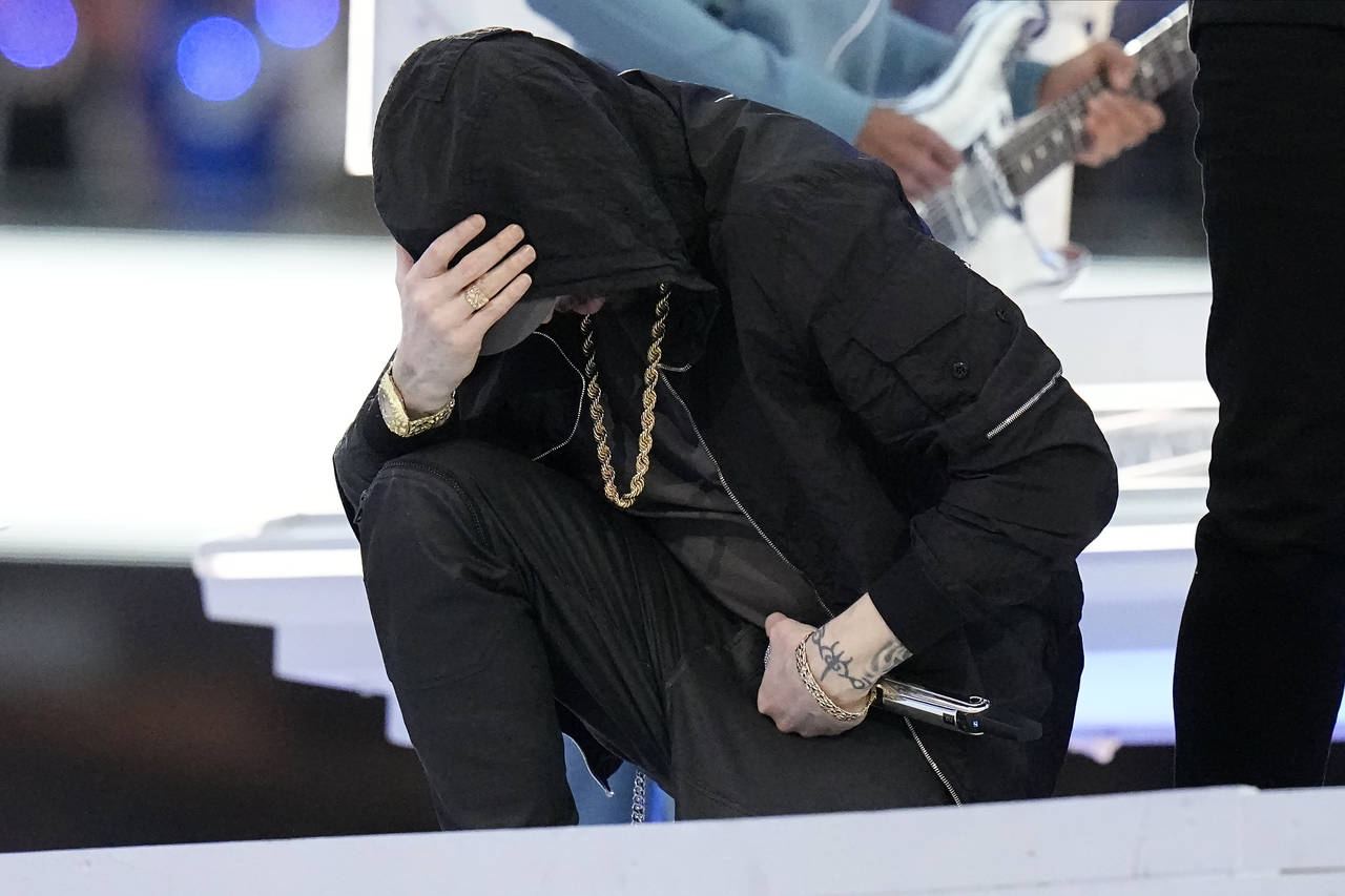 Eminem kneels down during the halftime performance at the NFL Super Bowl 56 football game between t...