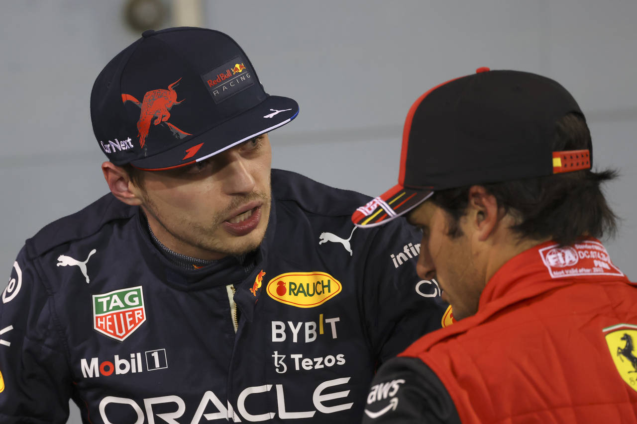 Red Bull driver Max Verstappen of the Netherlands, left talks to.Red Bull driver Sergio Perez of Me...